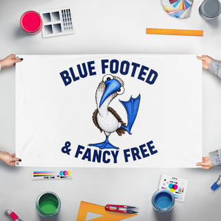 A mockup of the custom flag 'bluefooted flag' held up on a table during print checking