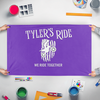 A mockup of the custom flag 'Tyler's Ride' held up on a table during print checking