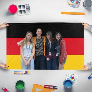 A mockup of the custom flag 'yay frau pari' held up on a table during print checking