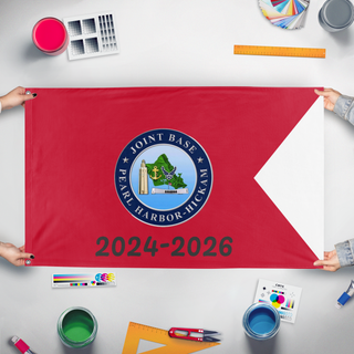 A mockup of the custom flag 'JBC Farewell' held up on a table during print checking