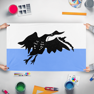 A mockup of the custom flag 'x' held up on a table during print checking