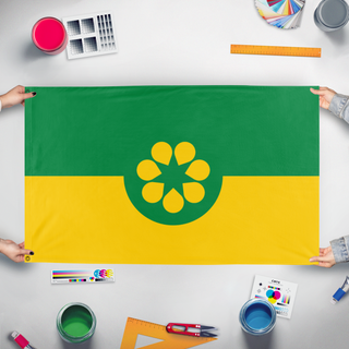 A mockup of the custom flag 'Golden Wattle flag' held up on a table during print checking
