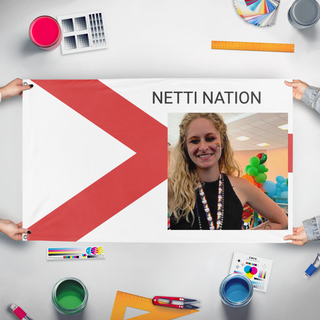 A mockup of the custom flag 'NETTI NATION flag' held up on a table during print checking