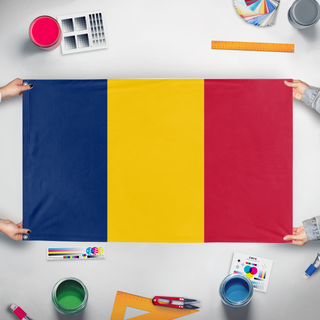 A mockup of the custom flag 'T flag' held up on a table during print checking