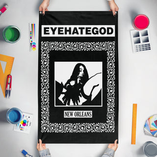 A mockup of the custom flag 'EYEHATEGOD flag' held up on a table during print checking