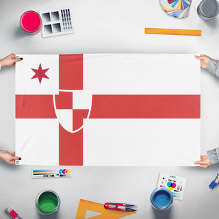 A mockup of the custom flag 'Chortland flag' held up on a table during print checking