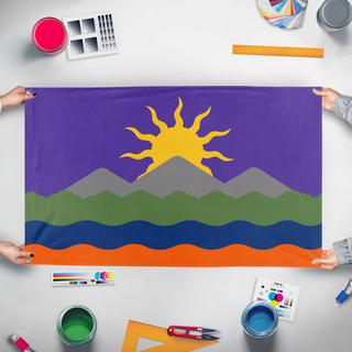 A mockup of the custom flag 'Sun Over Mountains flag' held up on a table during print checking