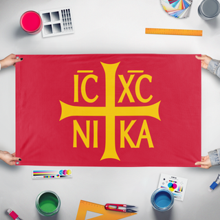 A mockup of the custom flag 'Mandylion / IC XC NIKA flag' held up on a table during print checking