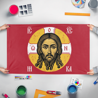 A mockup of the custom flag 'Mandylion Face of Christ flag' held up on a table during print checking