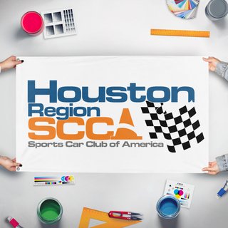 A mockup of the custom flag 'HouSCCA Basic flag' held up on a table during print checking