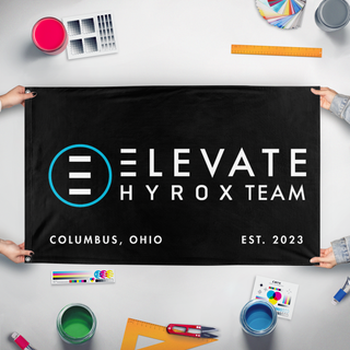 A mockup of the custom flag 'Elevate Hyrox flag' held up on a table during print checking