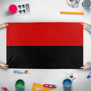 A mockup of the custom flag 'UPA flag' held up on a table during print checking