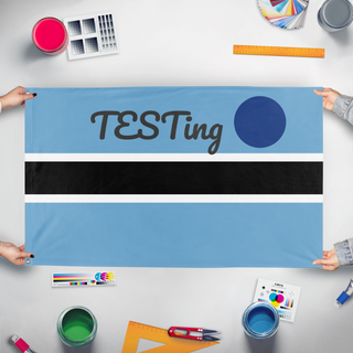 A mockup of the custom flag 'test flag' held up on a table during print checking