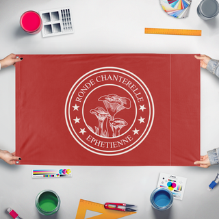 A mockup of the custom flag 'Chanterelle flag' held up on a table during print checking