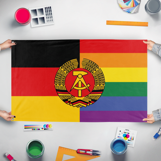 A mockup of the custom flag 'East Germany Pride flag' held up on a table during print checking