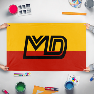 A mockup of the custom flag 'MD flag' held up on a table during print checking