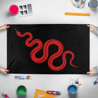 A mockup of the custom flag 'Red-Rattlesnake flag' held up on a table during print checking