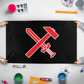 A mockup of the custom flag 'Strasserist flag' held up on a table during print checking