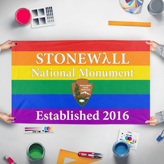 A mockup of the custom flag 'Stonewall National Monument Flag' held up on a table during print checking