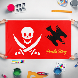 A mockup of the custom flag 'pirate king flag' held up on a table during print checking