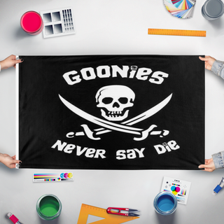 A mockup of the custom flag 'Goonies flag' held up on a table during print checking