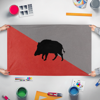 A mockup of the custom flag 'pest flag' held up on a table during print checking