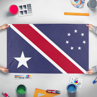 A mockup of the custom flag 'Distinct in Origin, United in Liberty flag' held up on a table during print checking