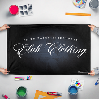 A mockup of the custom flag 'ELAH.CLOTHING flag' held up on a table during print checking
