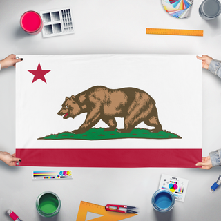 A mockup of the custom flag 'Minimalist California flag' held up on a table during print checking