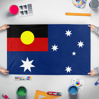 A mockup of the custom flag 'Australia flag with Aboriginal Flag Canton' held up on a table during print checking