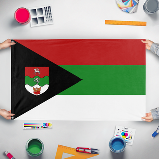 A mockup of the custom flag 'c flag' held up on a table during print checking