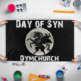 A mockup of the custom flag 'day of syn flag' held up on a table during print checking