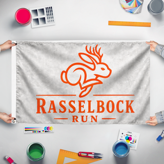 A mockup of the custom flag 'rasselbock flag' held up on a table during print checking