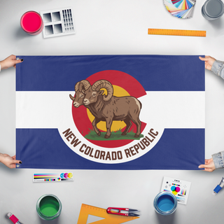A mockup of the custom flag 'New Colorado Republic flag' held up on a table during print checking