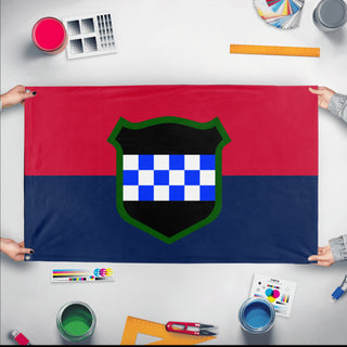 A mockup of the custom flag '99th RD  flag' held up on a table during print checking