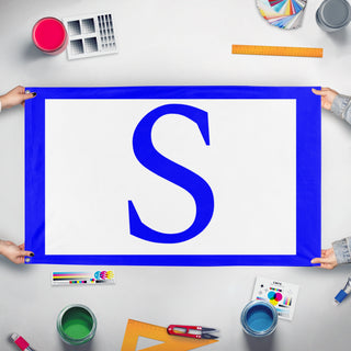 A mockup of the custom flag 'A. D. Stathatos flag' held up on a table during print checking