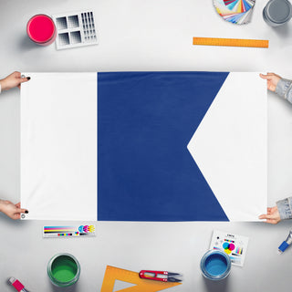 A mockup of the custom flag 'A flag' held up on a table during print checking