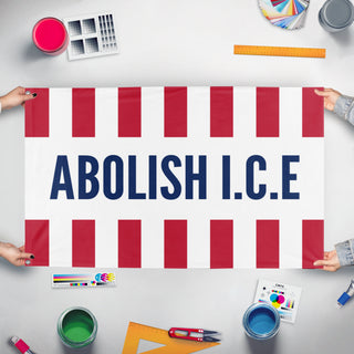 A mockup of the custom flag 'Abolish I.C.E flag' held up on a table during print checking