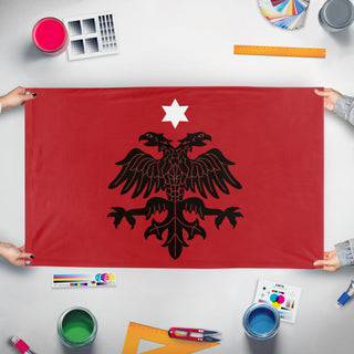 A mockup of the custom flag 'Albanian Provisional Government Flag' held up on a table during print checking