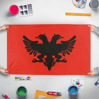 A mockup of the custom flag 'Albanian Provisional Government flag' held up on a table during print checking