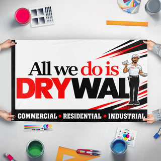 A mockup of the custom flag 'All We Do is Drywall flag' held up on a table during print checking