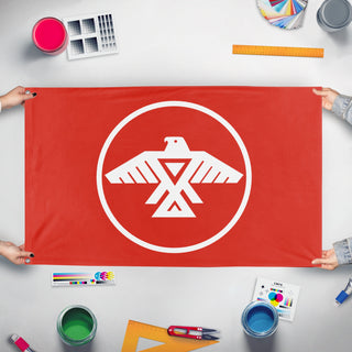 A mockup of the custom flag 'Anishinaabe First Nations Flag' held up on a table during print checking