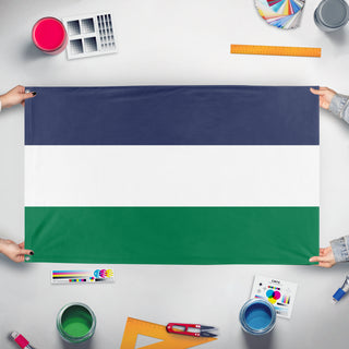 A mockup of the custom flag 'Cascadia Regional Flag' held up on a table during print checking
