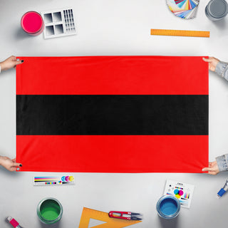A mockup of the custom flag 'Civil Ensign of Albania flag' held up on a table during print checking