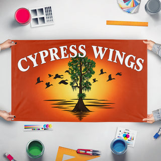 A mockup of the custom flag 'Cypress Wings flag' held up on a table during print checking