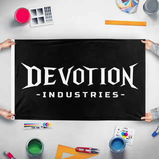 A mockup of the custom flag 'DEVOTION INDUSTRIES flag' held up on a table during print checking