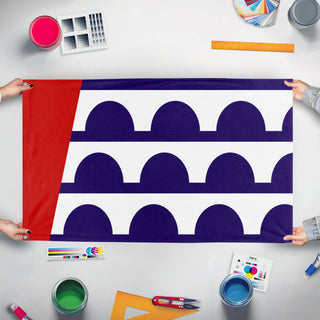 A mockup of the custom flag 'Des Moines Flag' held up on a table during print checking