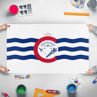 A mockup of the custom flag 'Flag of Cincinnati, Ohio' held up on a table during print checking