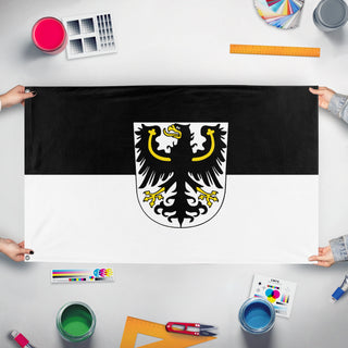 A mockup of the custom flag 'Flag of East Prussia' held up on a table during print checking