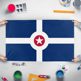 A mockup of the custom flag 'Flag of Indianapolis, Indiana' held up on a table during print checking